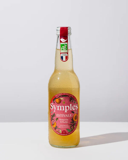 Symples infusion estivale in a glass bottle, featuring refreshing flavors of rosemary, citrus, and peach.